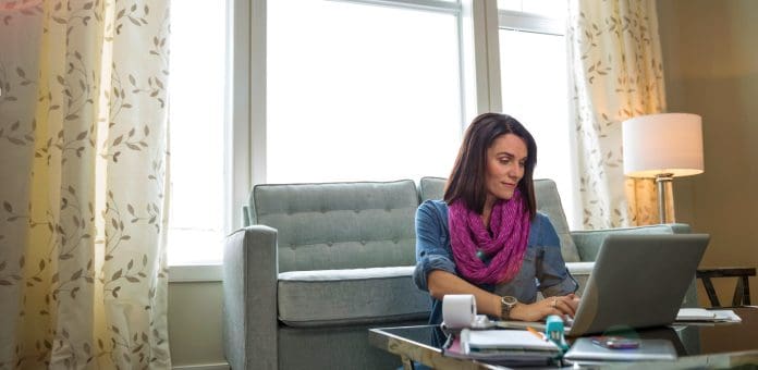 Woman on computer discussing feedback to her business partner.