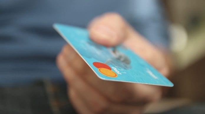 Man handing Mastercard