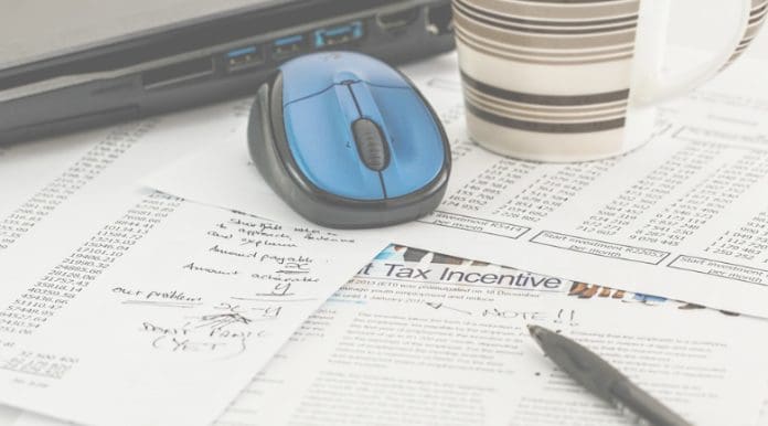 Coffee and mouse over tax paperwork.