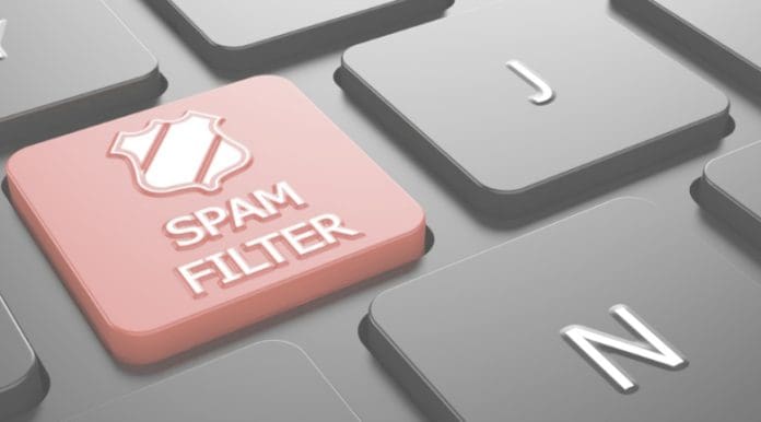 Spam Filter with Shield Icon - Red Button on Black Computer Keyboard. artisinal spam filter