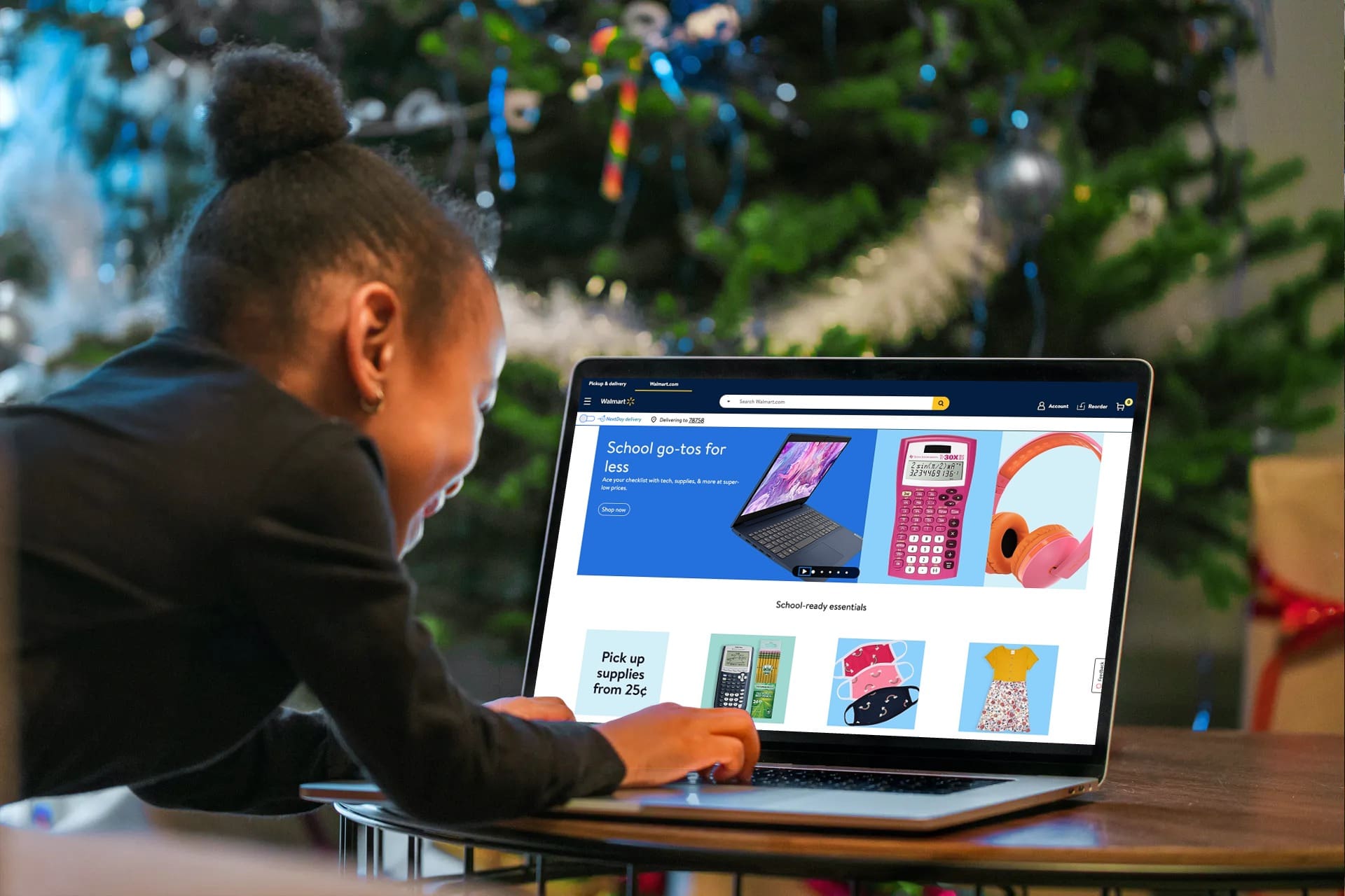 girl looking at walmart home screen on laptop