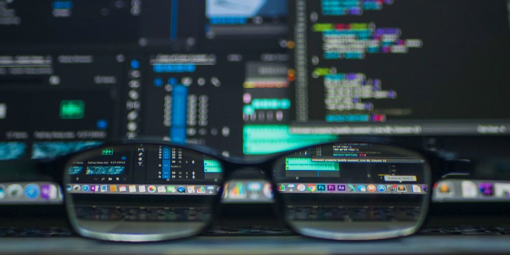 Glasses sitting on an open laptop with potential spyware