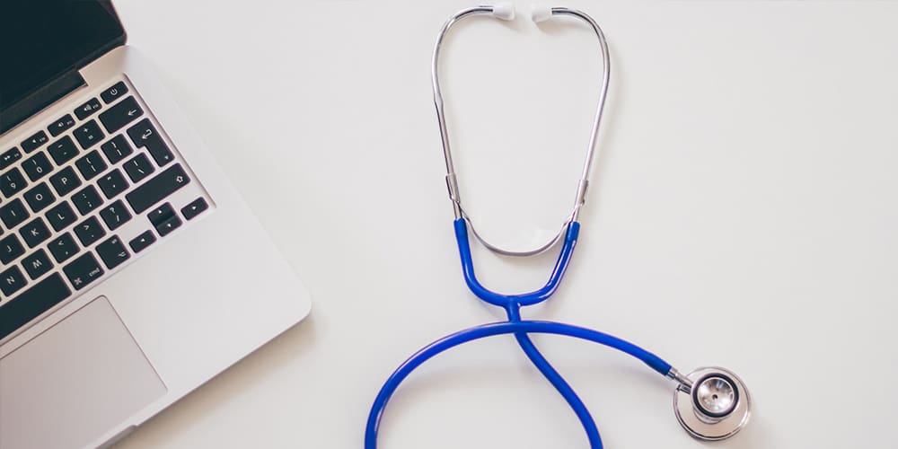 Stethoscope with laptop, showing healthcare going virtual.