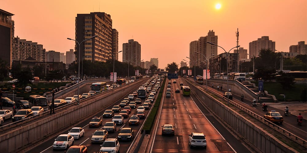 Cars driving on city highway, including more than one self-driving car in the future.