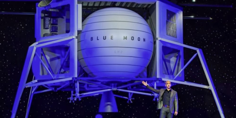 Jeff Bezos standing in front of very large Blue Moon spacecraft.