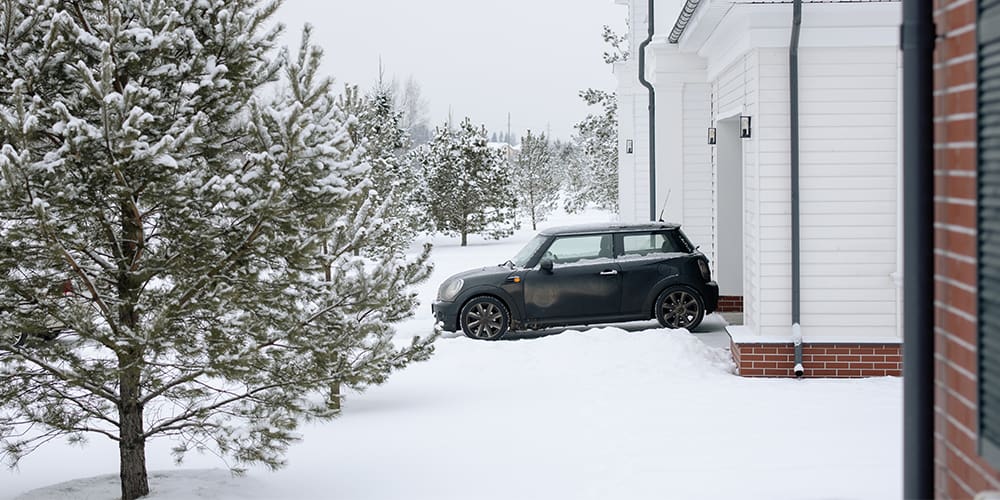 Snow storm disaster, inches of snow where it was unexpected in front of a home and car.