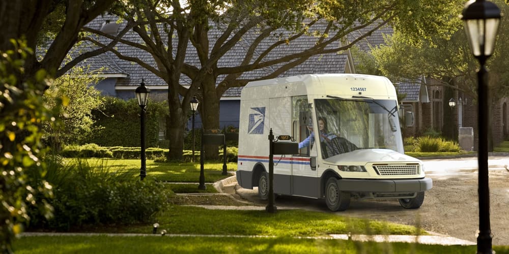 New USPS truck in a fictional neighborhood delivering mail.