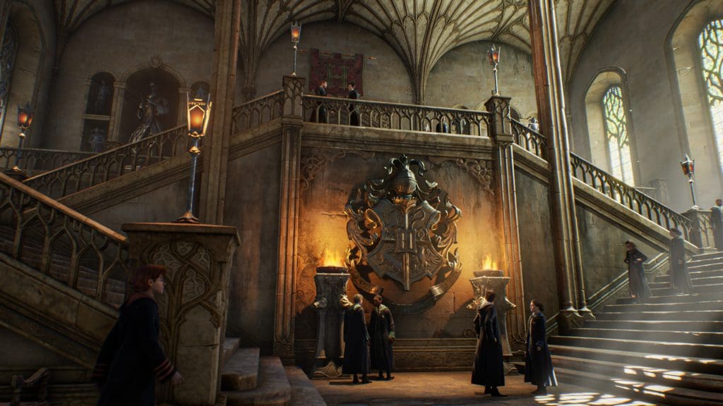 A screenshot of Hogwarts Legacy showing off the main hall and several wizarding students walking around.