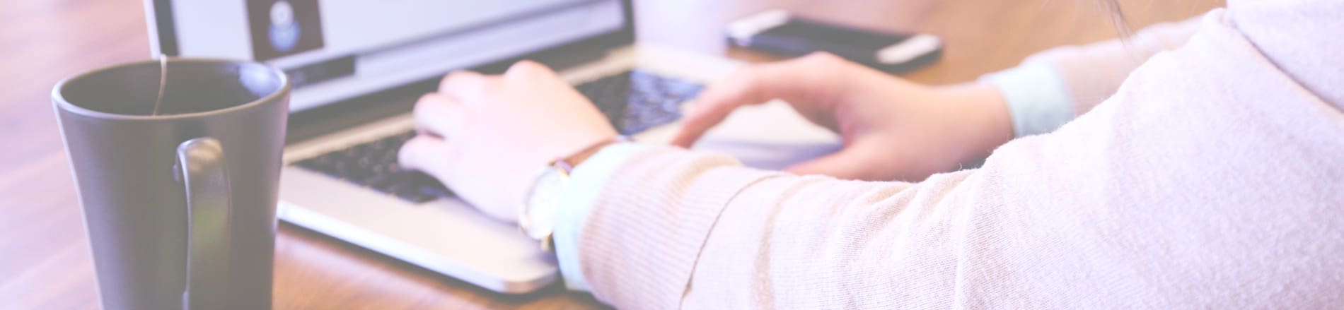 Person typing on computer representing collecting feedback.