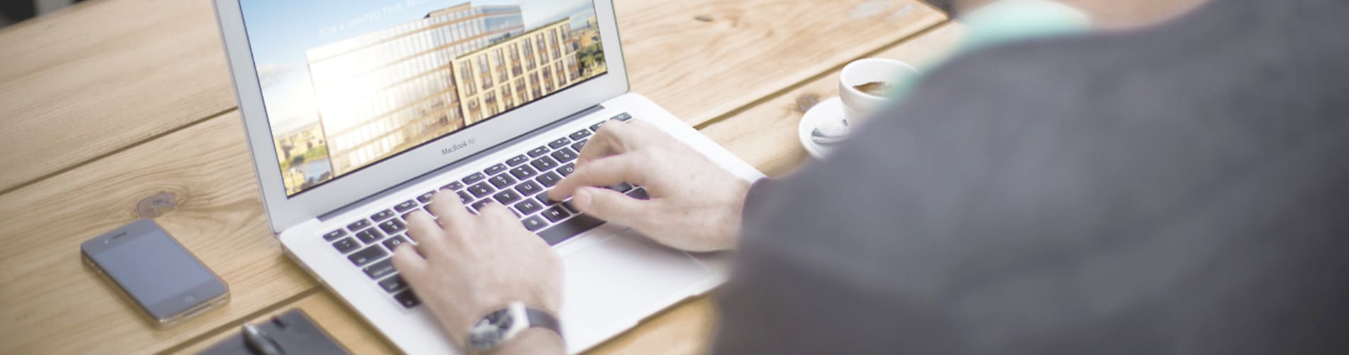 Person typing on computer representing habits in our workday.