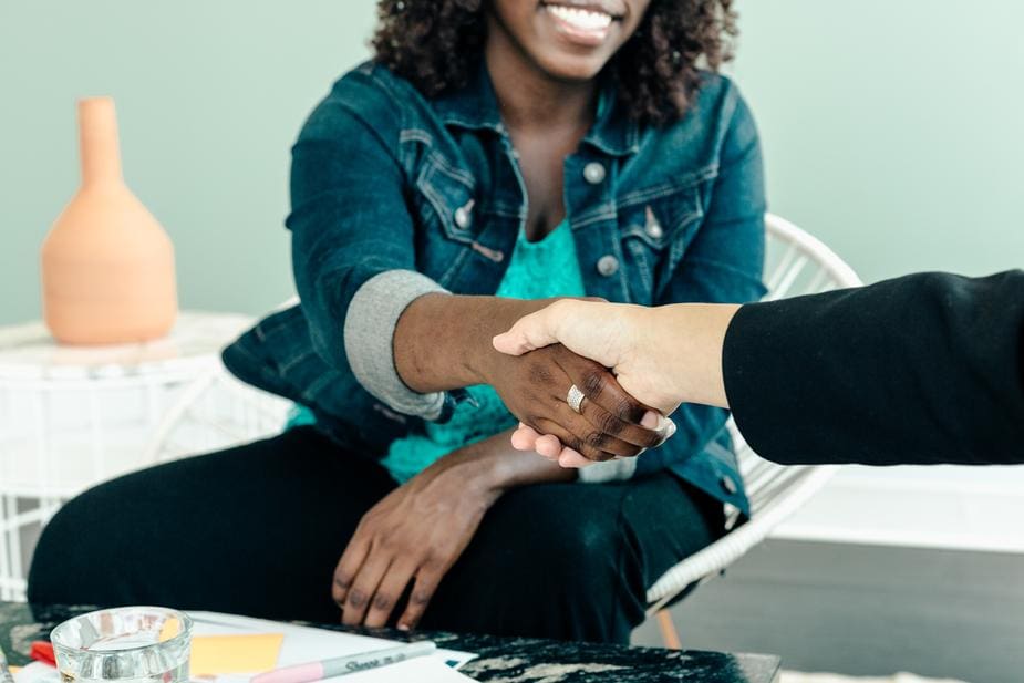 Handshake between two people representing networking representing the question technique.