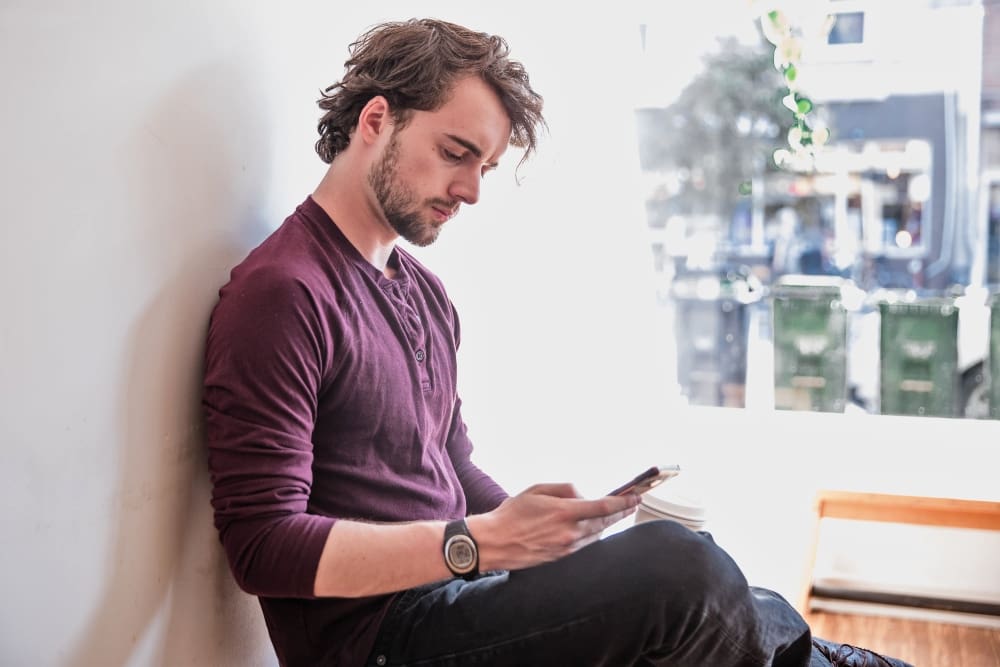 Man texting on phone representing client psychology.