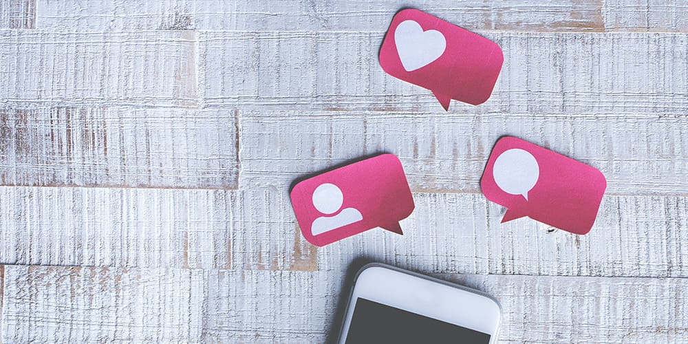 Instagram symbols on paper over a phone, analytics tracking that.