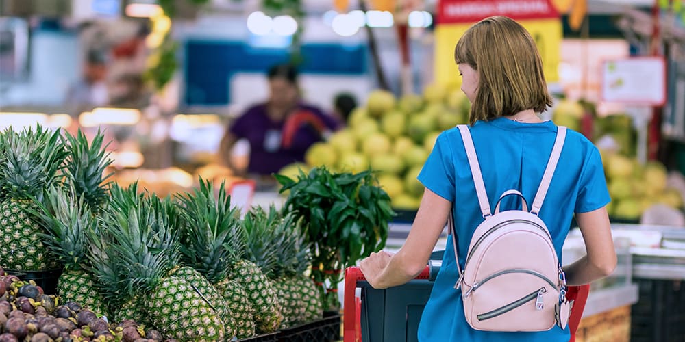 Woman grocery shopping, showing economy changes