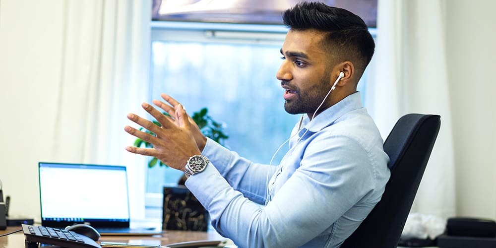 Man talking on virtual meeting about a competitor moving close next door.