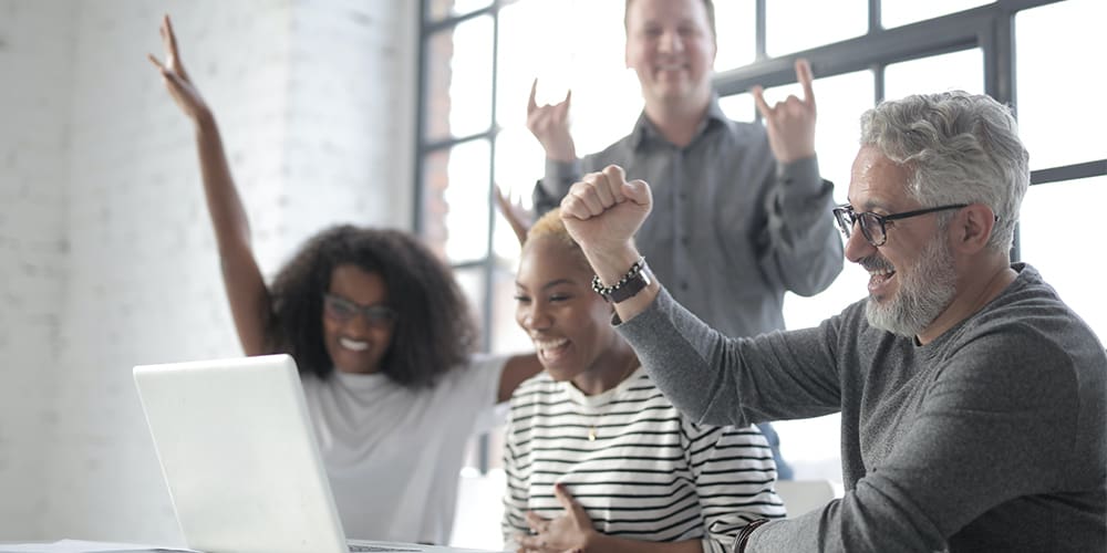 Team building with virtual icebreakers around a computer.