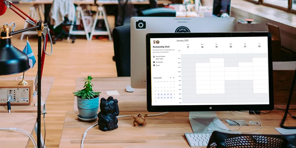 Computer on a desk in open office with SavvyCal, a scheduling tool, open on the computer.