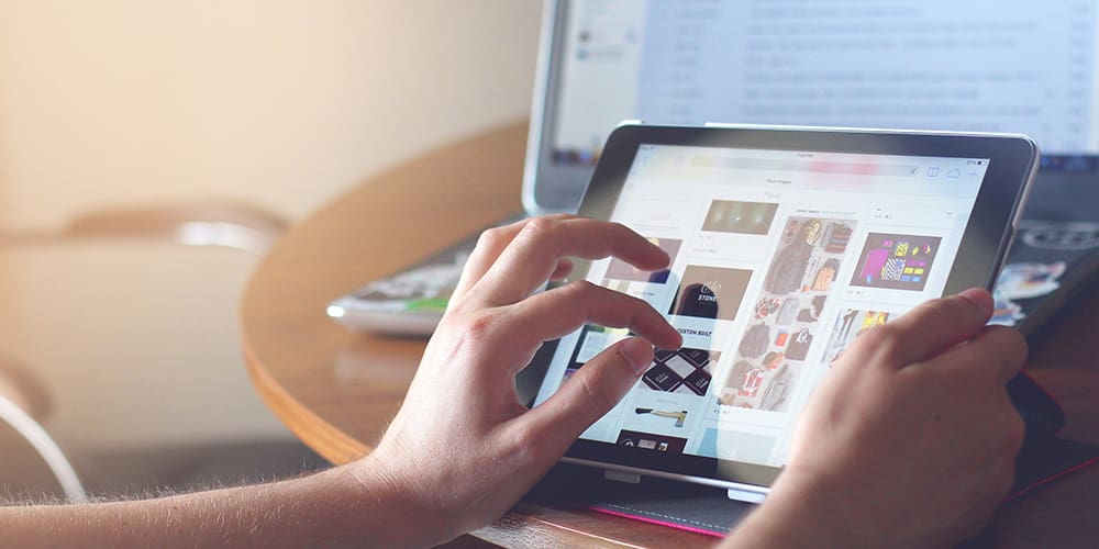 E-commerce on Twitter on a tablet, open in front of a desktop computer..