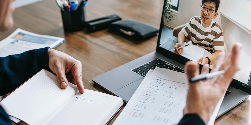 Mentor speaking with his mentee over mentorship video.