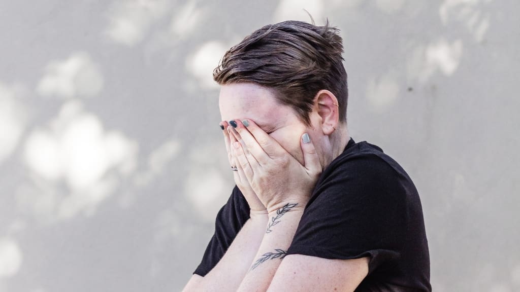 woman with face in hands dealing with comparison