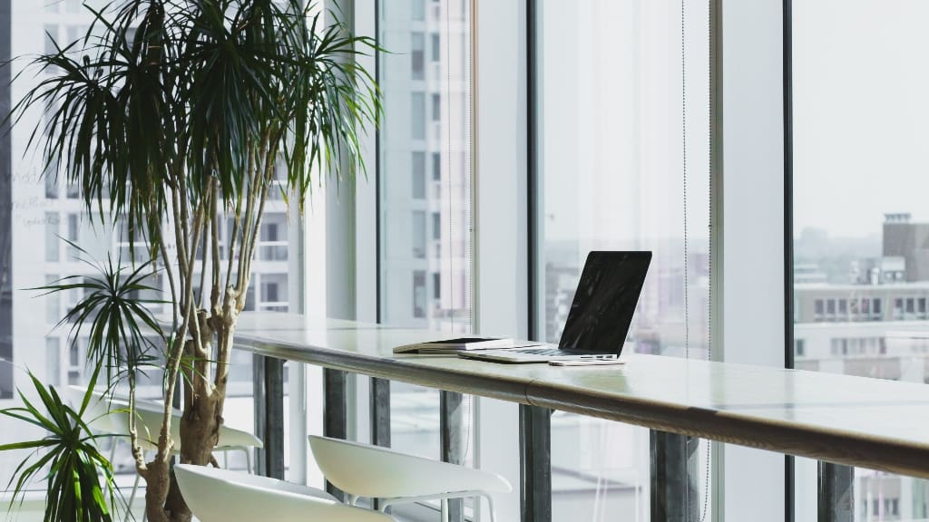 Open office floor plan with bar-style seating and a laptop