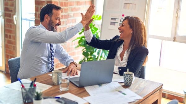 Two people high-fiving, representing chemistry in mentorship