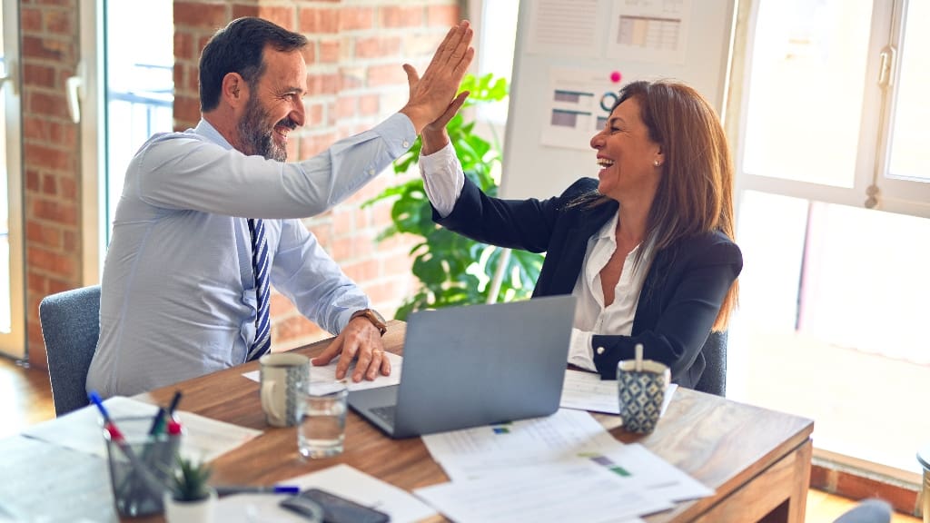 Two people high-fiving, representing chemistry in mentorship