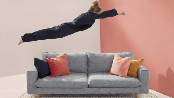 person flying to couch after work