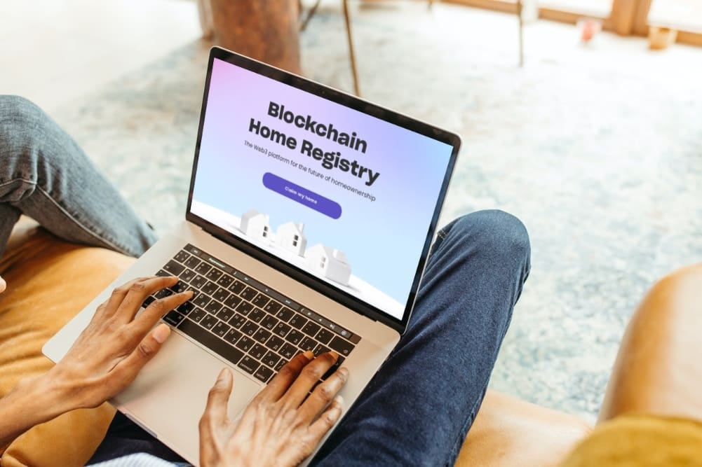 Man using laptop to look at Blockchain Home Registry