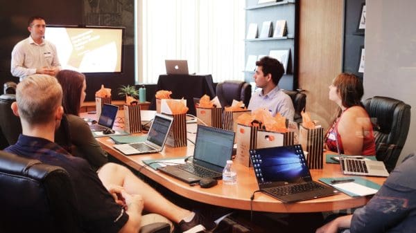 people sitting around large table for meeting at work