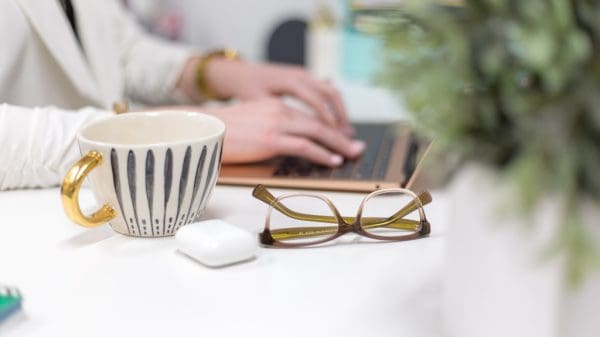Person working at desk with apple airpods