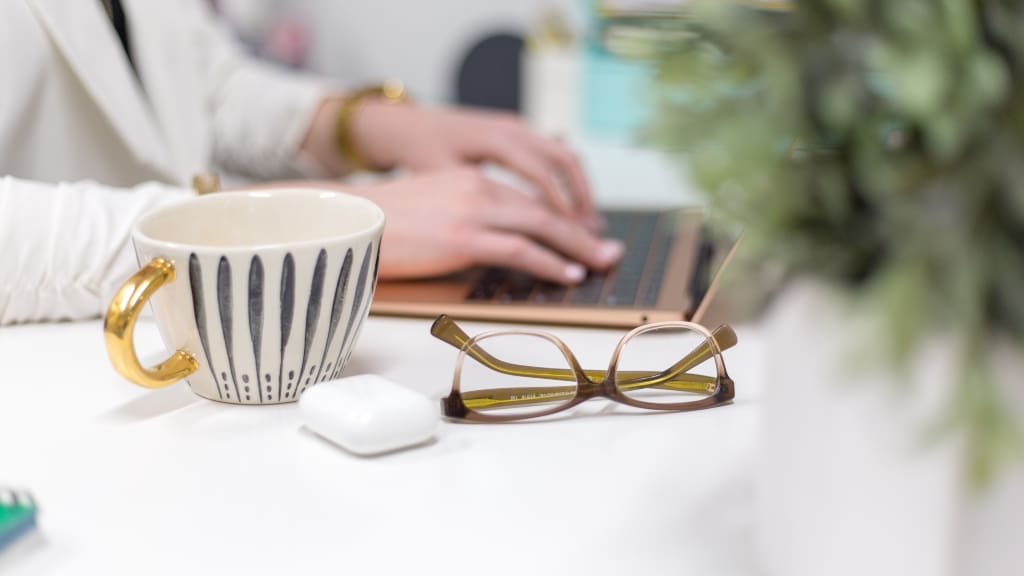 Person working at desk with apple airpods
