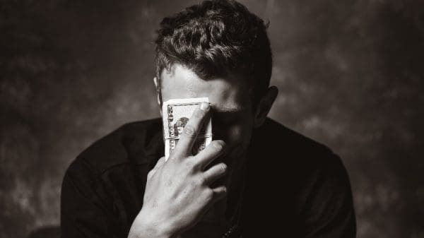 Person holding money representing increasing inflation