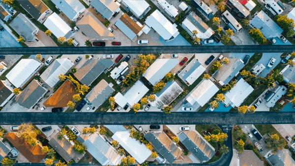 An aerial view of a neighborhood in diagonal lines from each other, showing part of the housing market.